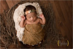 baby girl wrapped and posed in bowl
