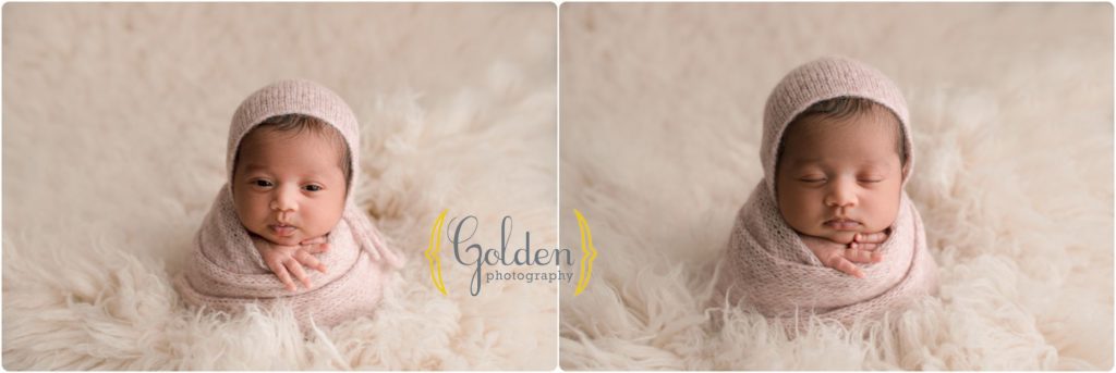 baby girl wrapped on white rug smiling