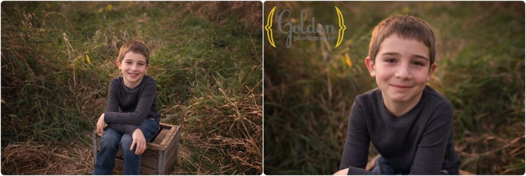 boy seated on a box in the grass at sunset in Chicago IL
