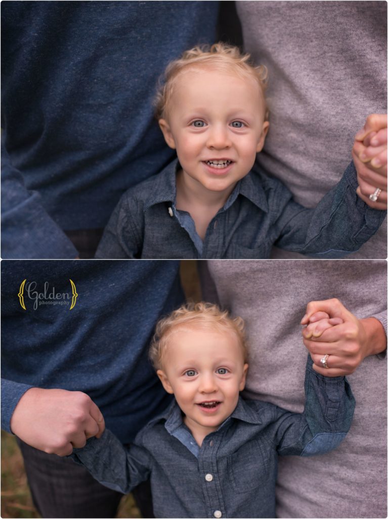 close up of little boy holding mom and dad's hands
