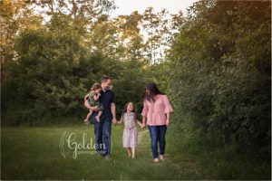 family of four holding hands and walking outside near Libertyville IL