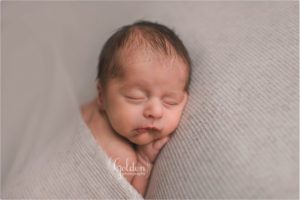 baby boy sleeping in newborn studio