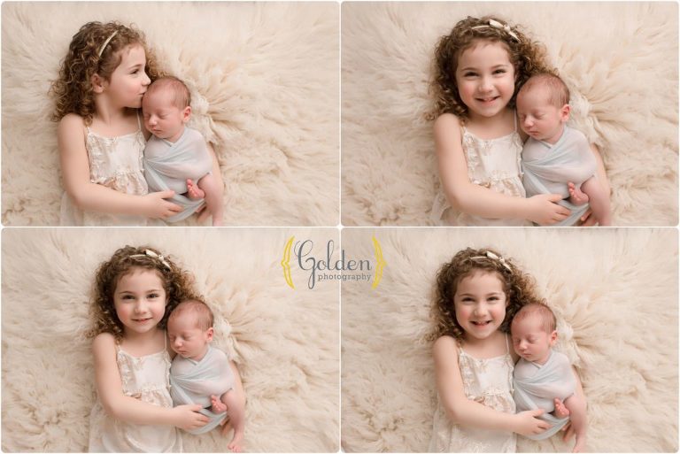 big sister holding newborn brother in Lake County photography studio