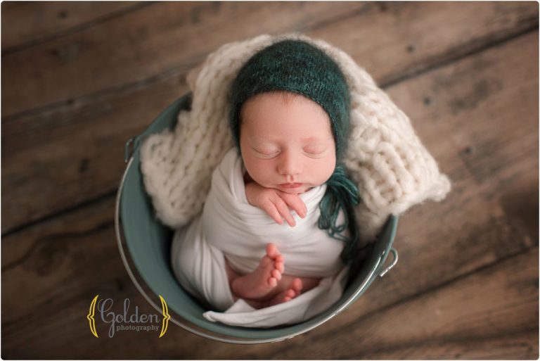 baby boy wrapped in bucket in Lake Zurich photo studio