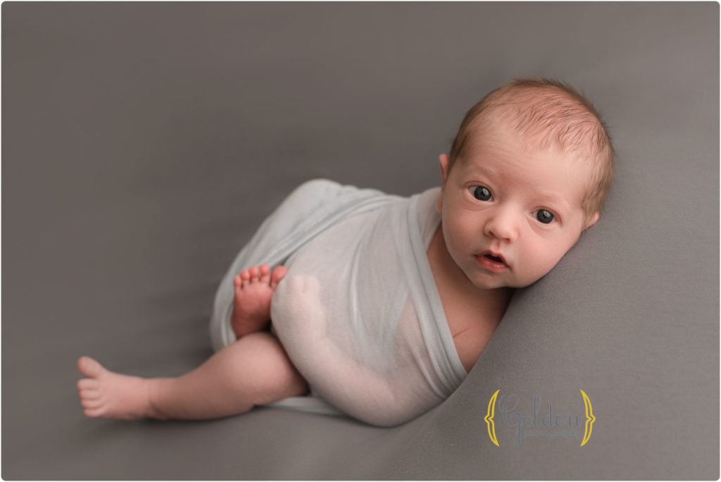 baby boy wrapped and awake in photo studio in Lake County IL
