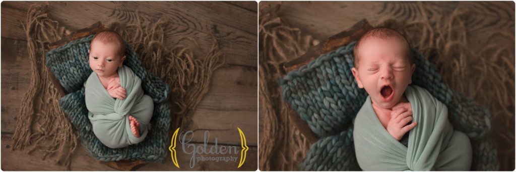newborn yawning posed in wooden crate