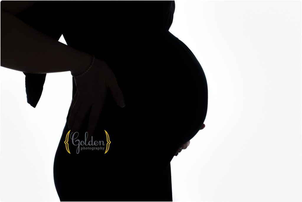 silhouette of pregnant belly on white background in Lake County IL photo studio