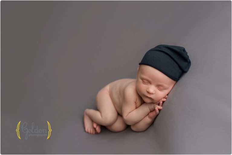 baby boy wearing blue hat in Golden Photography photo studio