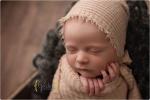 newborn wrapped and sleeping in crate in best newborn photo studio Lake Zurich IL