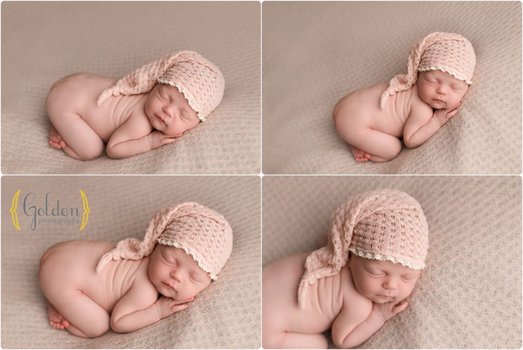 newborn baby girl asleep with pink hat in photo studio near Barrington IL