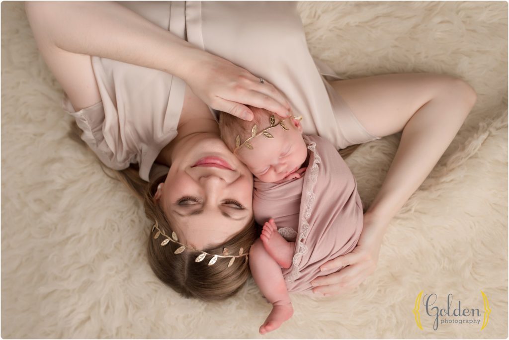 mom laying down with newborn baby girl