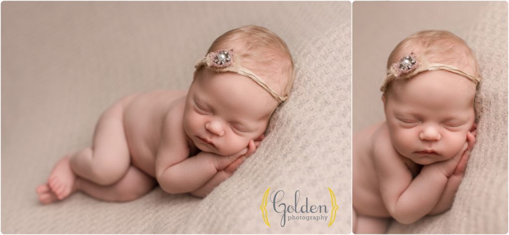 newborn baby girl wearing headband asleep in photo studio near Libertyville IL
