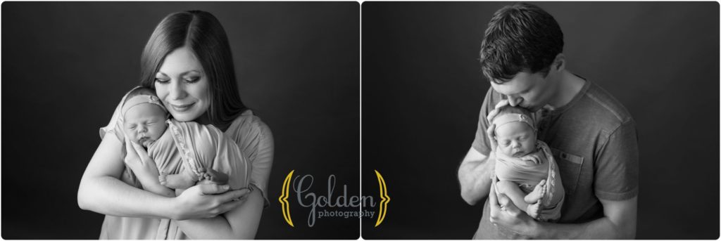 black and white photo parents holding baby in photography studio near Vernon Hills IL
