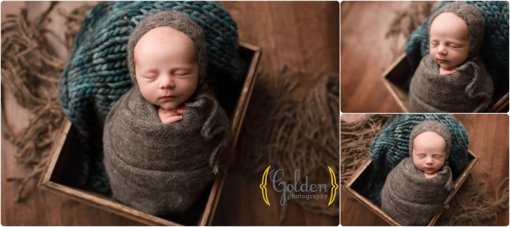 baby boy swaddled in crate in photo studio near Arlington Heights IL