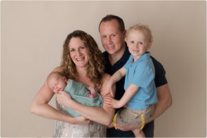 family of 4 with newborn baby in Lake County IL photography studio