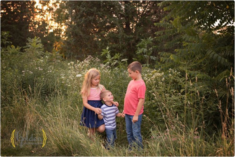 siblings pose outdoors with Chicago family photographer