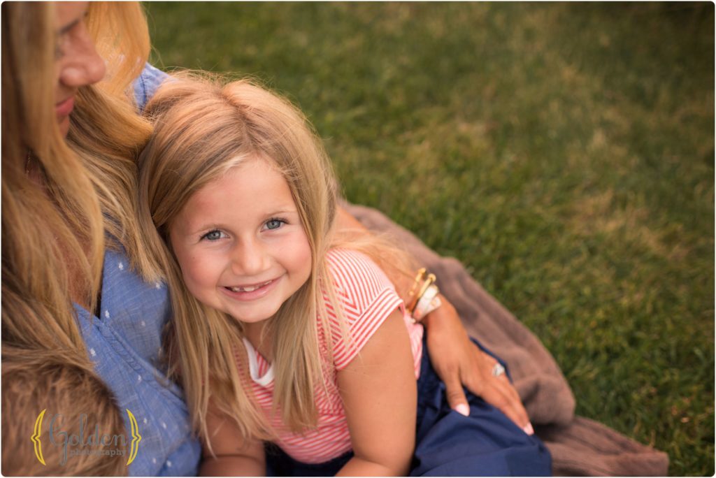 daughter snuggles with mom during family photos near Palatine IL