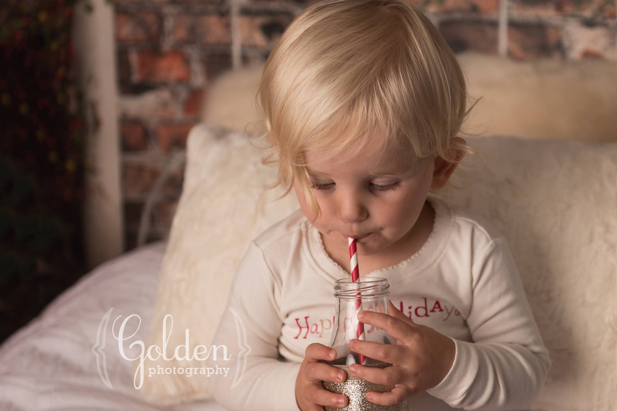 child drinks milk in Chicago photo studio for Christmas photos