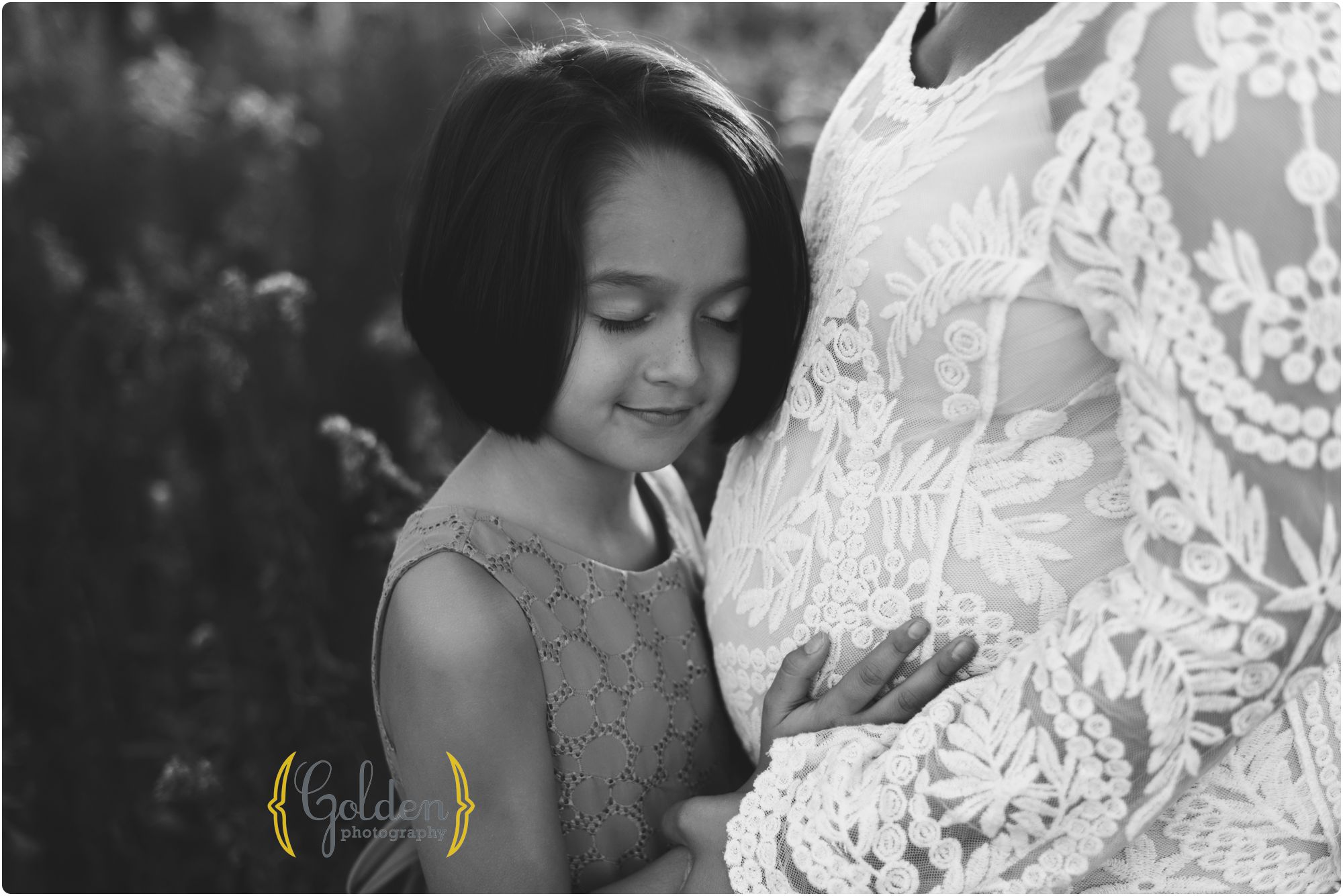 sister hugging mom's belly with best maternity photographer in Chicago IL