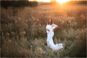 mom wearing white pregnancy dress outdoors Chicago IL