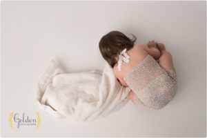girl snuggling with blanket for 1 year photos near Chicago IL