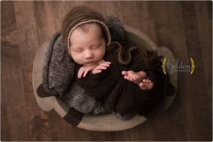 newborn wrapped in bowl in photo studio Chicago IL
