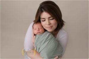 new mom holding baby in photo studio near Arlington Heights IL