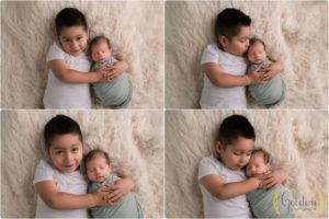 boy holding newborn brother in photo studio near Barrington IL