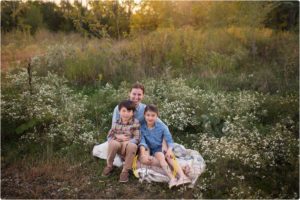 family of thee outdoors pose for best family photographer Chicago IL