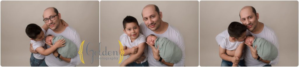 dad with baby and son in photo studio with Deerfield IL newborn photographer