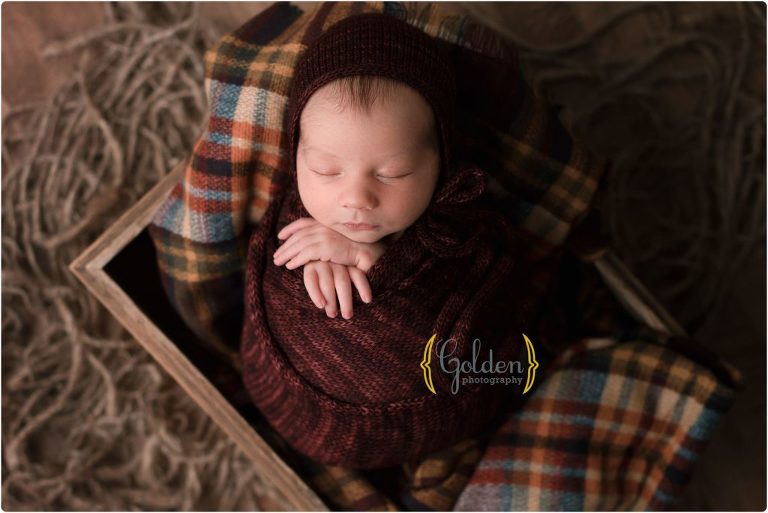 baby boy swaddled in dark red in Lake County IL for newborn baby photos