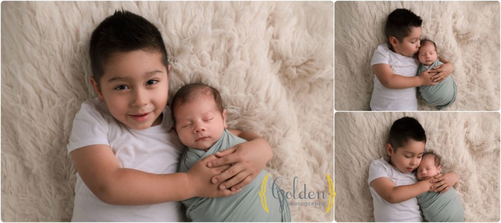 boy with new baby brother in Lake County IL newborn photo studio