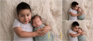 boy with new baby brother in Lake County IL newborn photo studio