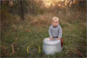 toddler wearing sweater stands outside at sunset near Buffalo Grove IL
