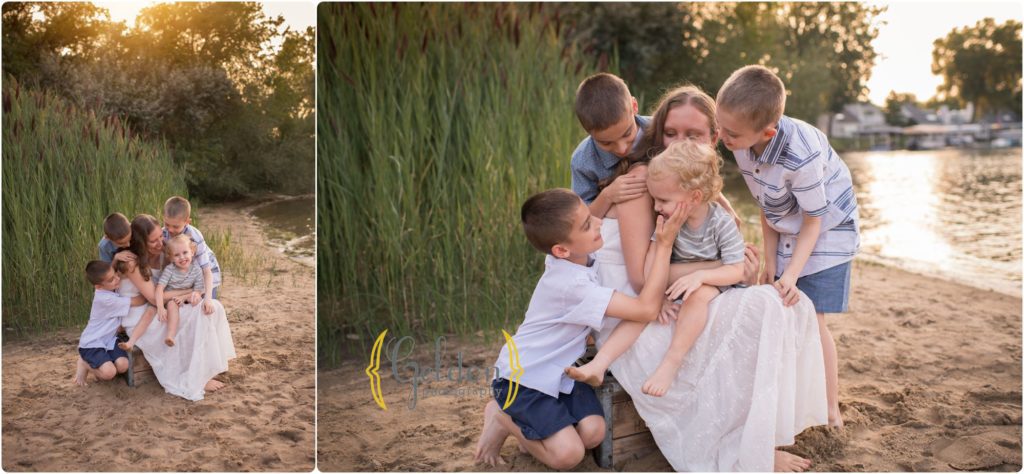 mom sitting on a beach with her four boys during outdoor family photos in Lake County IL