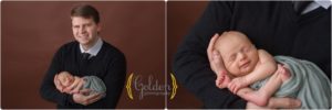 dad holding newborn baby boy in Palatine IL newborn photography studio