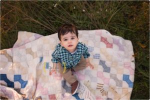 boy sitting on quilt with best family photographer near Chicago IL