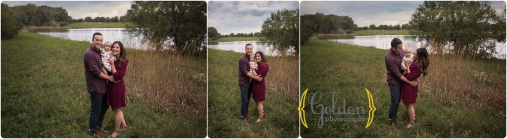 family of three outdoors by a pond in Schaumburg IL forest preserve during 6 month baby photos