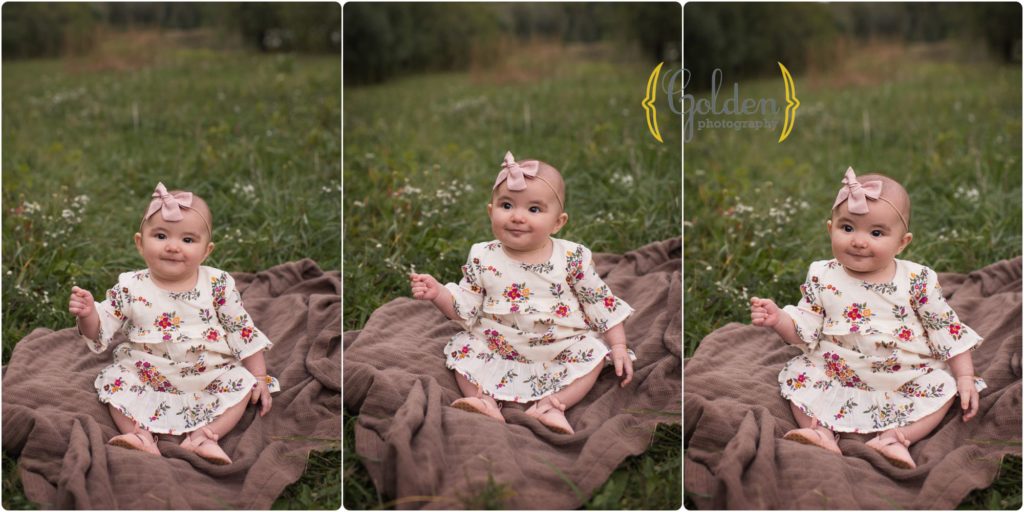 baby girl sitting outdoors on a blanket for family photos in a forest preserve near schaumburg IL