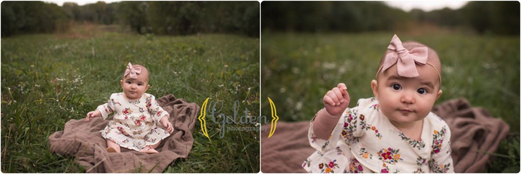 smiling baby girl sits outside during family portrait session with best family photographer near Schaumburg IL