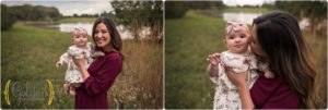 mom holding baby girl outdoors during family photo session in Cook County IL