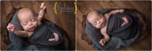 baby boy wrapped and stretching during his photo session in Barrington Illinois photo studio