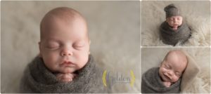baby boy wrapped in grey posed for newborn photos in Barrington IL studio