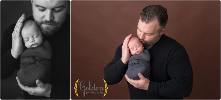 dad holding newborn baby boy in photo studio in Lake County IL