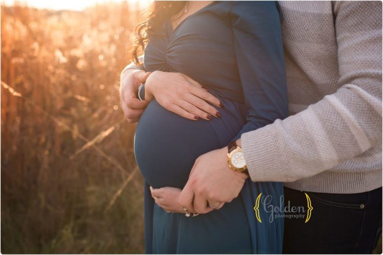 couples hands on pregnant belly for outdoor pregnancy photos in Glenview IL