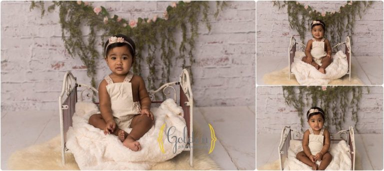 little girl sitting on tiny bed for 1st birthday photo session in Lake County IL
