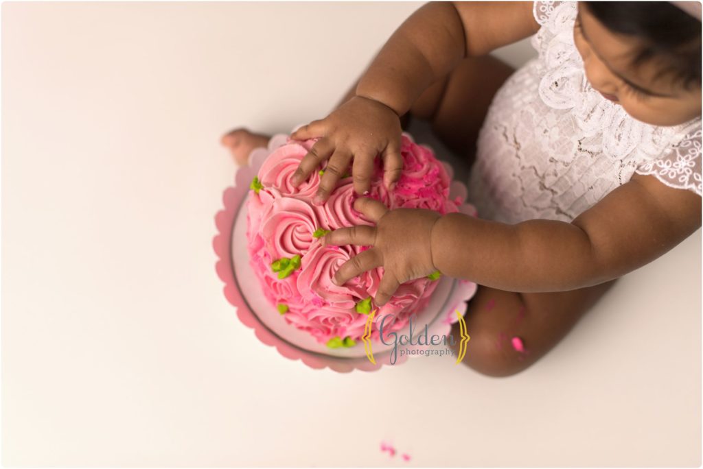 1 year old hands on pink cake with cake smash photographer near Cook County IL