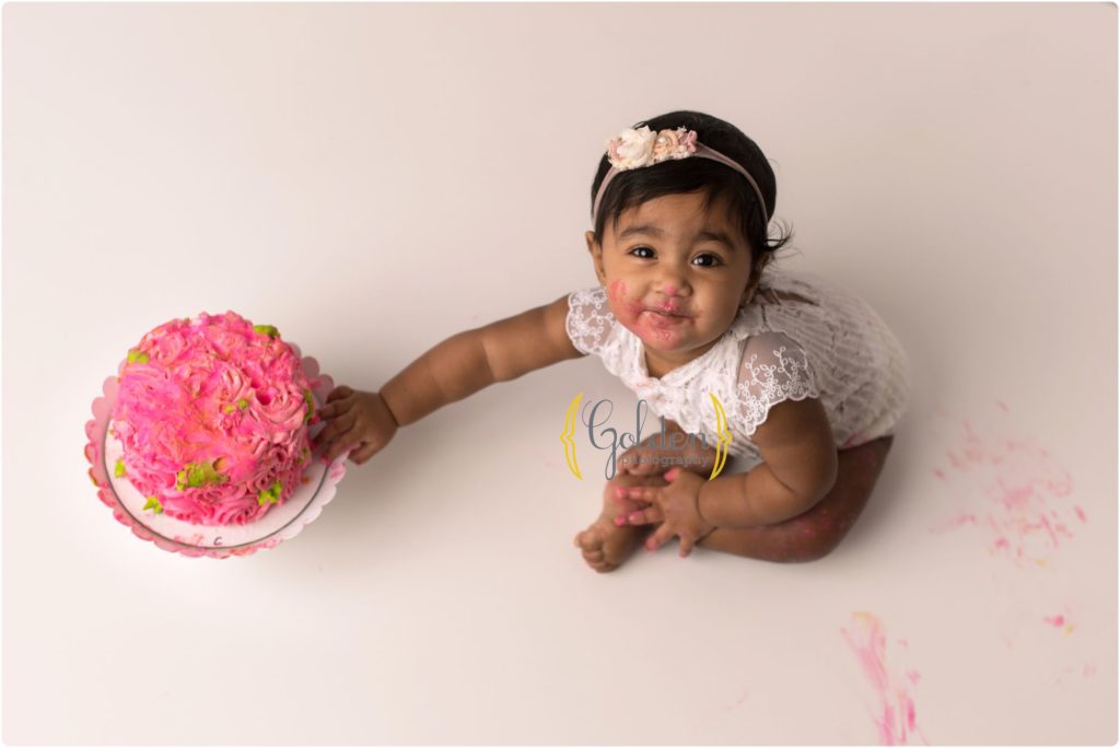 little girl with pink smash cake for a photo session in Lake Zurich IL