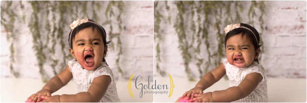 little girl smiling for 1st birthday cake smash photos in Lake Zurich IL photo studio