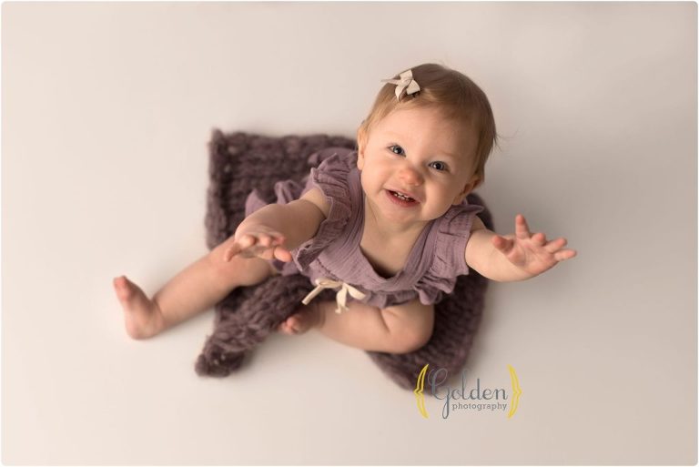 baby girl reaching up during photo session in Barrington